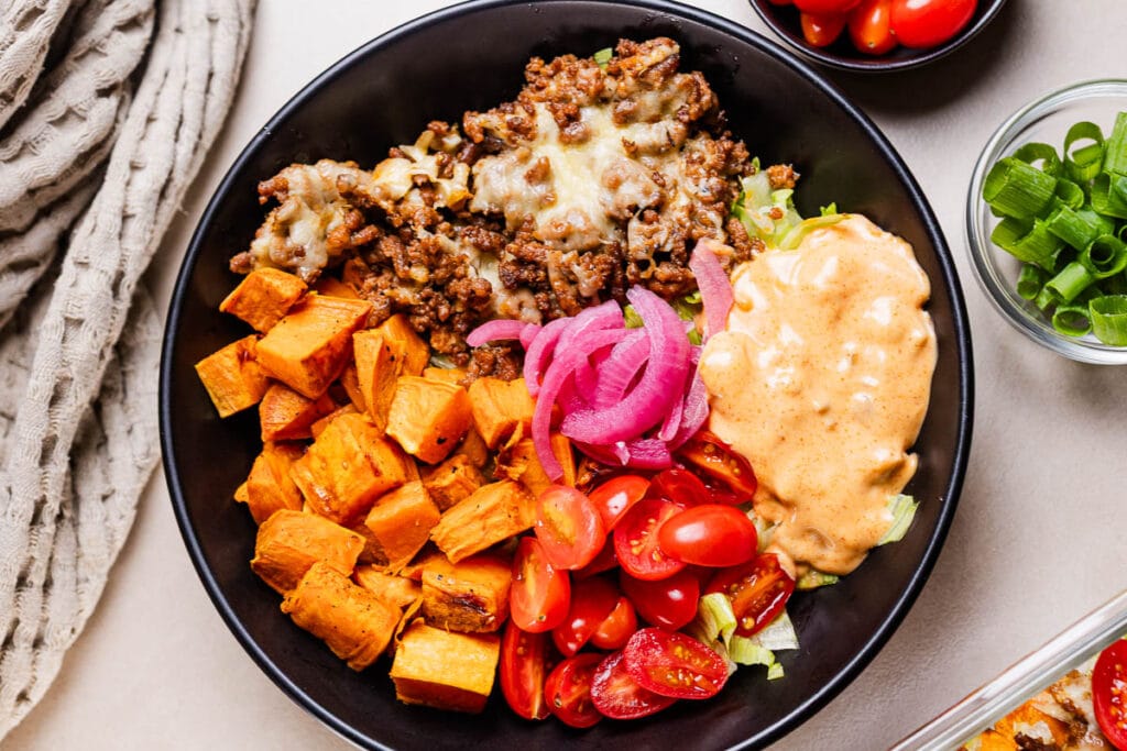 This a photo of the viral cheese burger bowl in a black bowl.