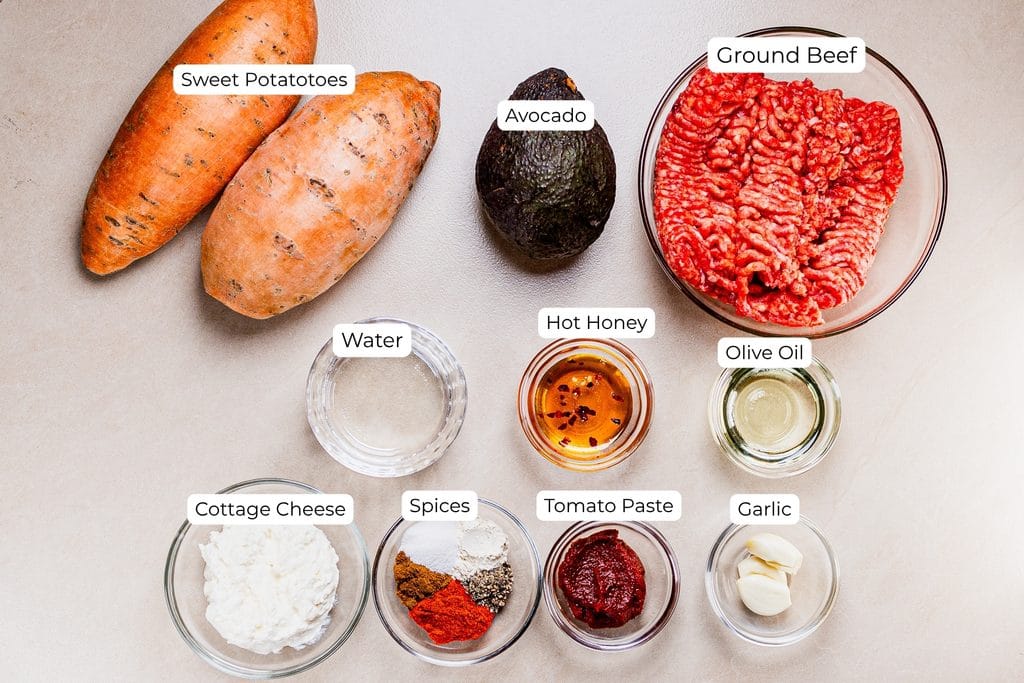 This is an image of a loaded baked sweet potato with ground beef and cottage cheese ingredients.