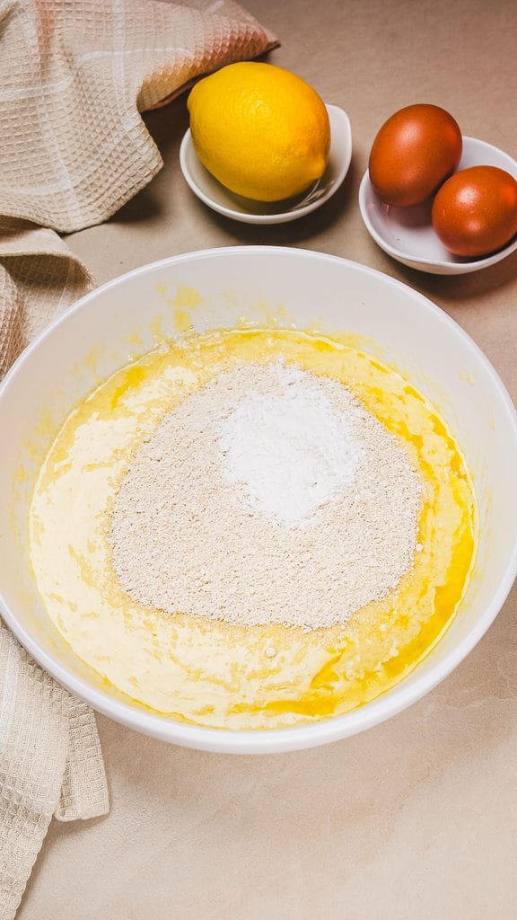 Greek yogurt, eggs, oat flour, and other ingredients mixed together to make high protein blueberry pancake batter.